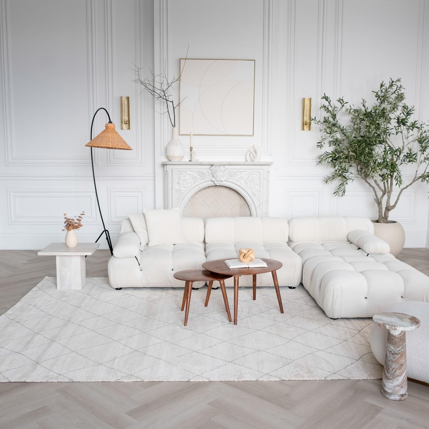 Modern living room with white sectional and plants.