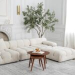 Modern living room with white sofa and round table.