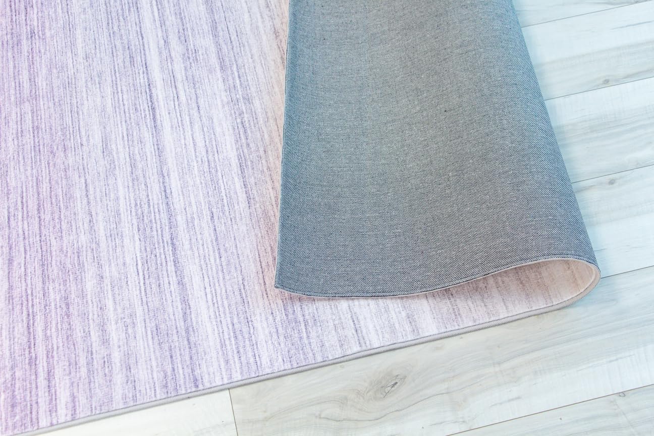 Rolled gray and purple area rug on floor