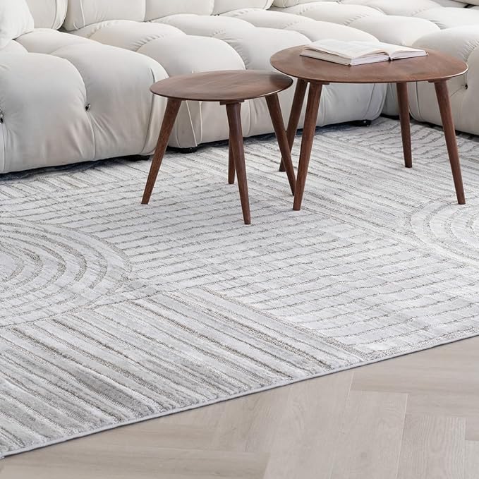 Modern coffee tables on patterned rug with sofa