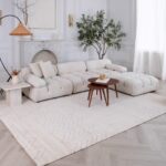 Elegant living room with white sofa and decor.