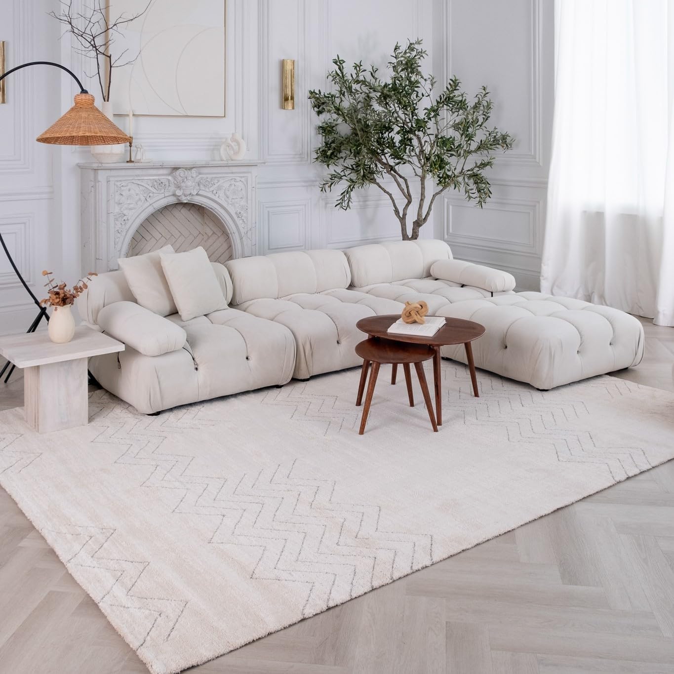 Elegant living room with white sofa and decor.