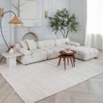 Modern living room with white sofa and decor.
