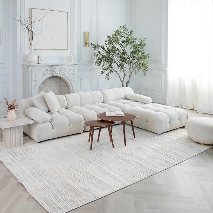 Elegant living room with white sofa and fireplace.