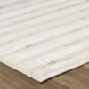 Beige striped carpet on wooden floor surface.