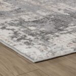 Gray abstract pattern rug on wooden floor.