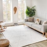 Modern living room with gray sofa and plants.