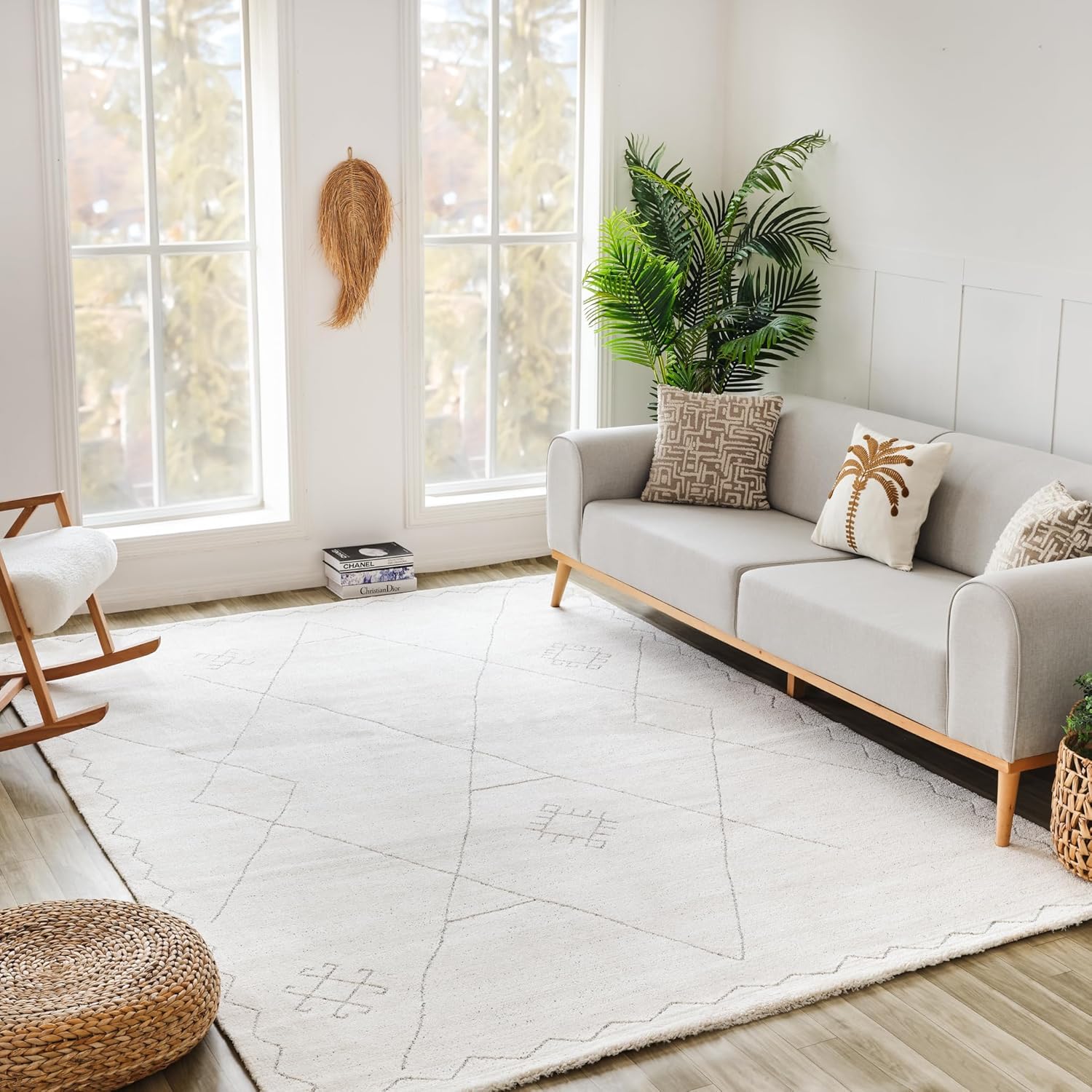 Modern living room with gray sofa and plants.