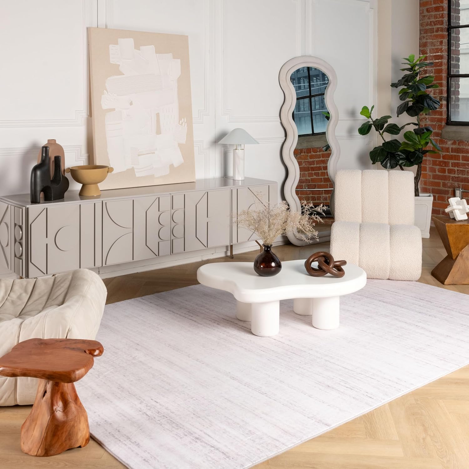Modern living room with abstract decor and furniture.