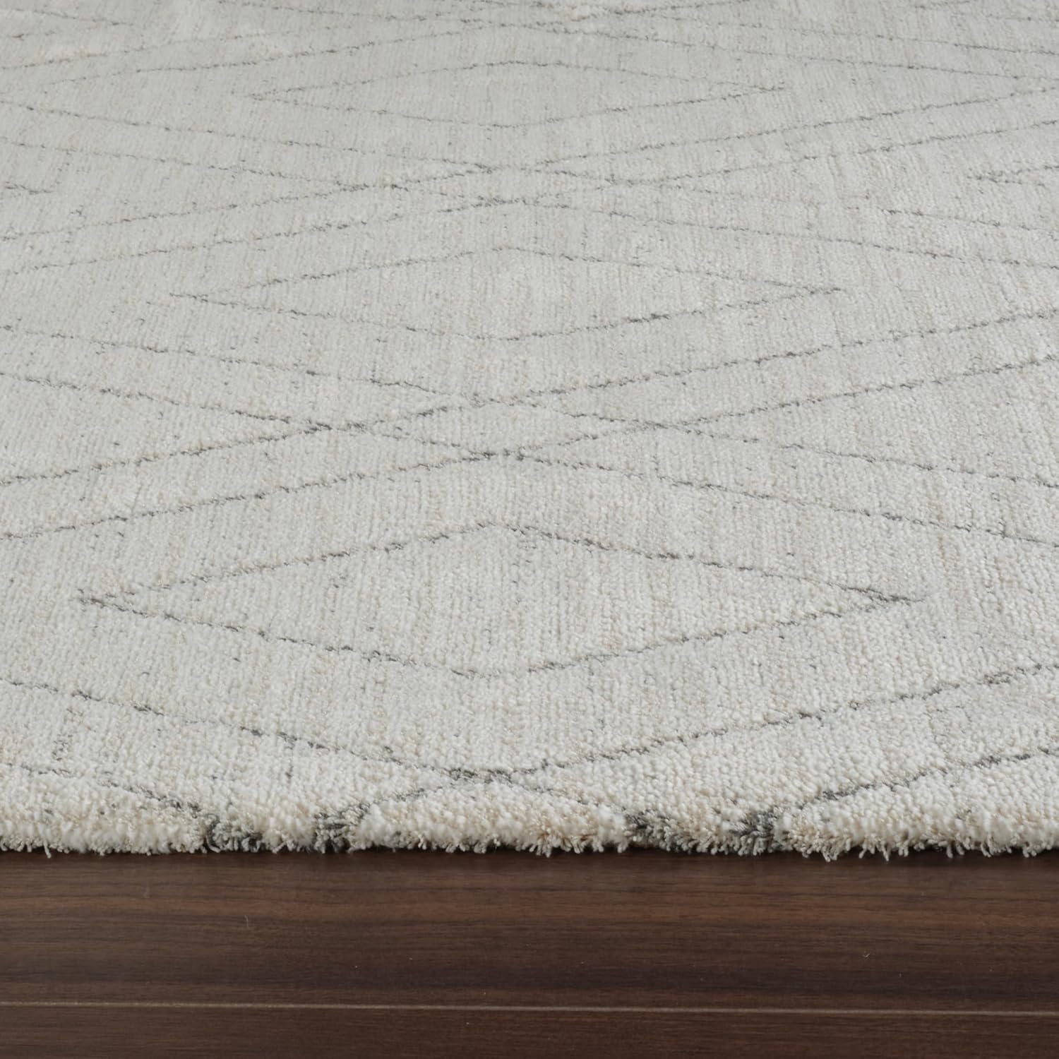 Cream rug with geometric pattern on hardwood floor
