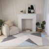 Modern living room with geometric rug and decor.