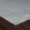 Soft gray carpet on dark wooden floor