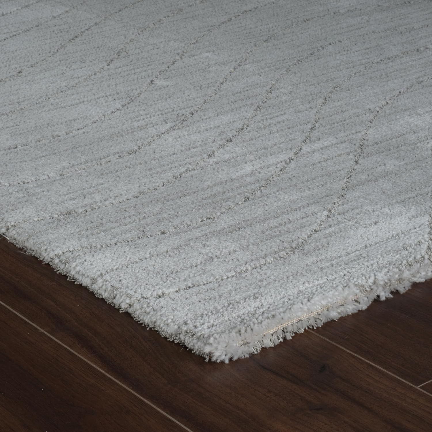 Soft gray carpet on dark wooden floor