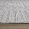 Close-up of gray striped rug on wooden floor.