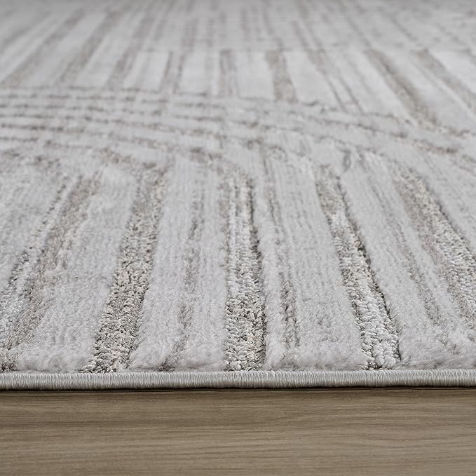 Close-up of gray striped rug on wooden floor.