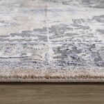 Close-up of textured beige and gray area rug.
