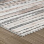 Striped area rug on wooden floor
