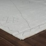 Close-up of white rug with geometric patterns