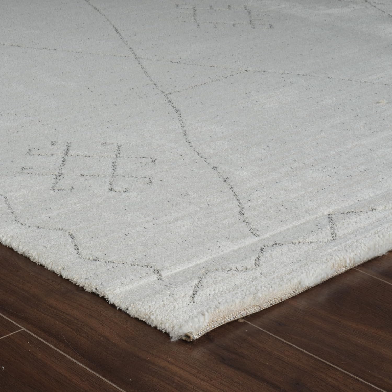 Close-up of white rug with geometric patterns