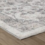 Beige and gray pattern rug on wooden floor.
