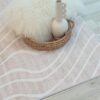 White rug with vase and fluffy cushion
