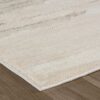 Beige shag rug on wooden floor.