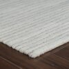 White textured rug on wooden floor