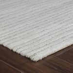 White textured rug on wooden floor