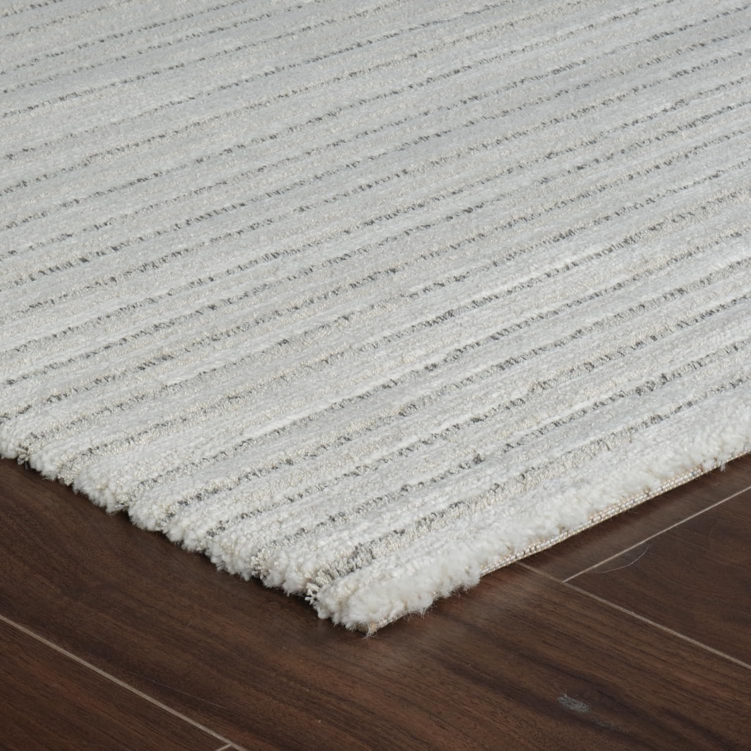 White textured rug on wooden floor