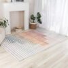 Colorful striped rug by fireplace and plants