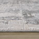 Close-up of geometric patterned rug on floor.