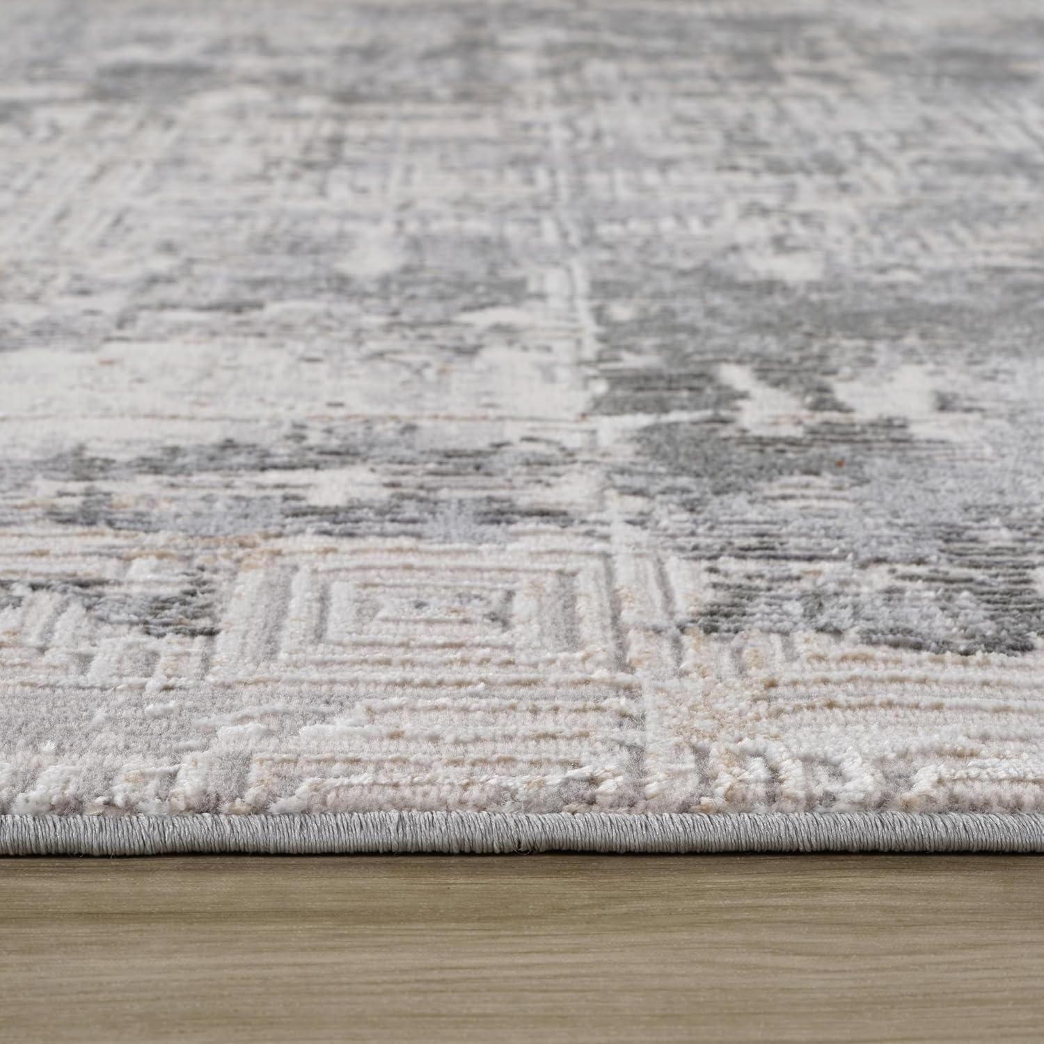 Close-up of geometric patterned rug on floor.