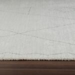 Textured white rug on dark wood floor.