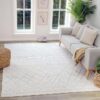 Bright living room with patterned white rug.