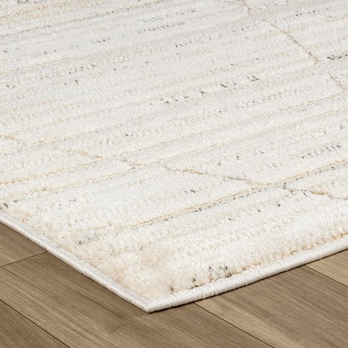 Beige textured rug on wooden floor.