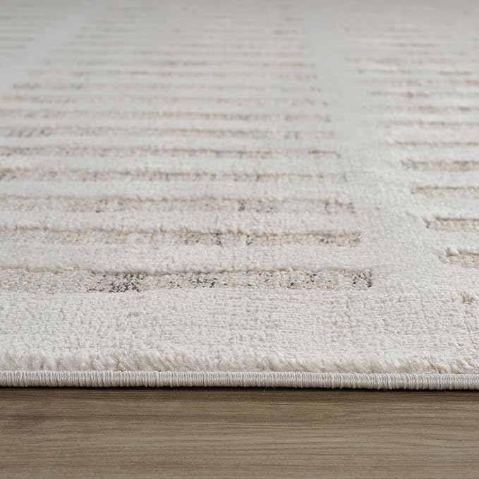 Close-up of textured white rug on wooden floor.