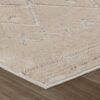 Close-up of beige textured rug on wooden floor.
