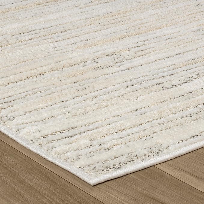 Beige textured rug on wooden floor