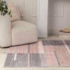 Modern chair and geometric rug in living room.
