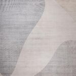 Beige rug with abstract curved line patterns