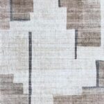 Beige abstract geometric patterned rug.