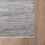 Gray striped rug on wooden floor
