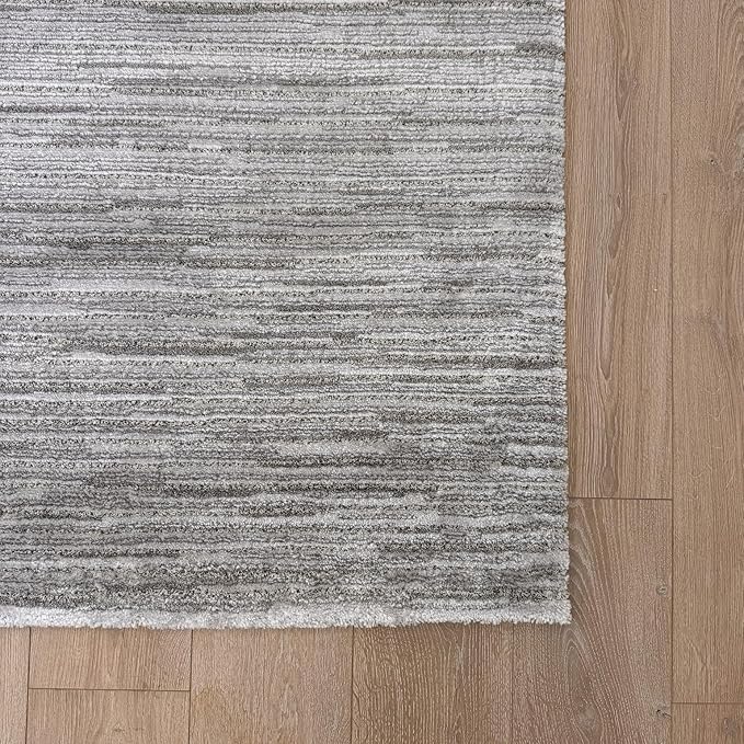 Gray striped rug on wooden floor