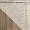 Corner of rug folded on wooden floor