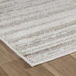 Beige textured rug on wooden floor
