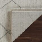 Folded rug corner on wooden floor.