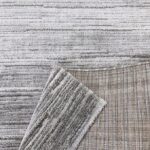 Grey textured rugs and fabric samples.