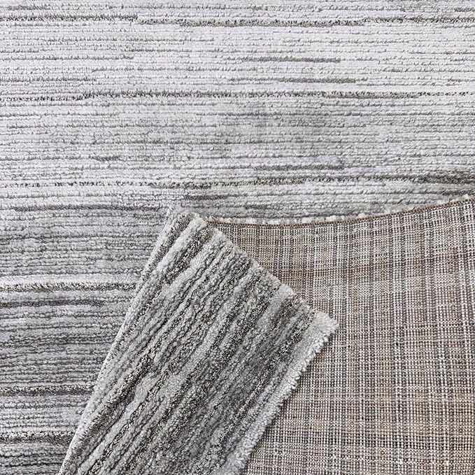 Grey textured rugs and fabric samples.
