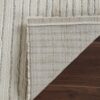 Striped rug on wooden floor corner folded