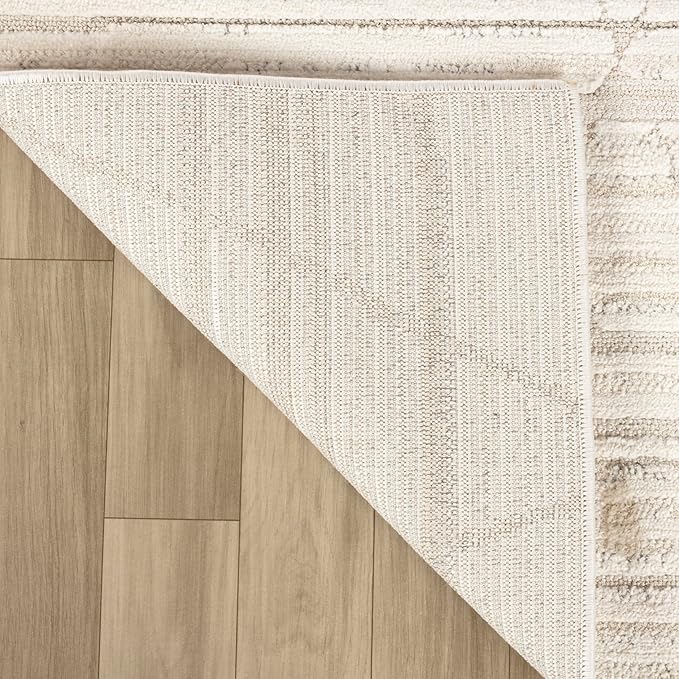 Beige area rug corner flipped on wood floor